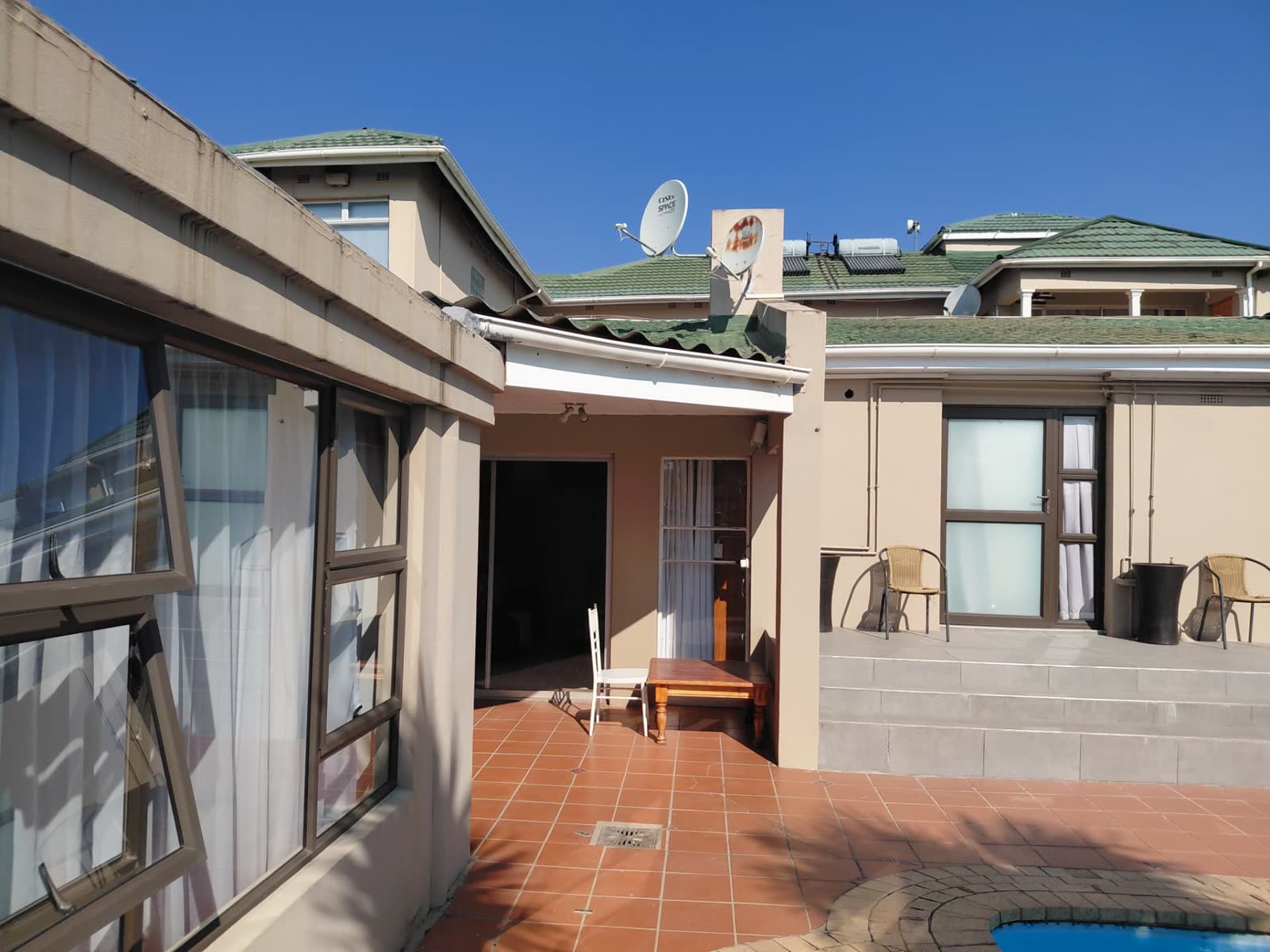 Pool courtyard with tiled patio and guest room entrances