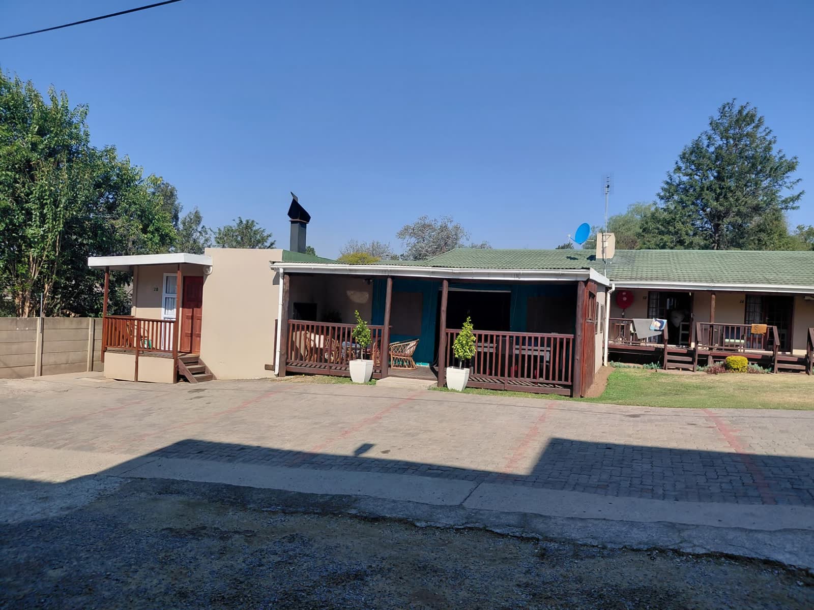 Guesthouse frontage with wooden verandas and private parking
