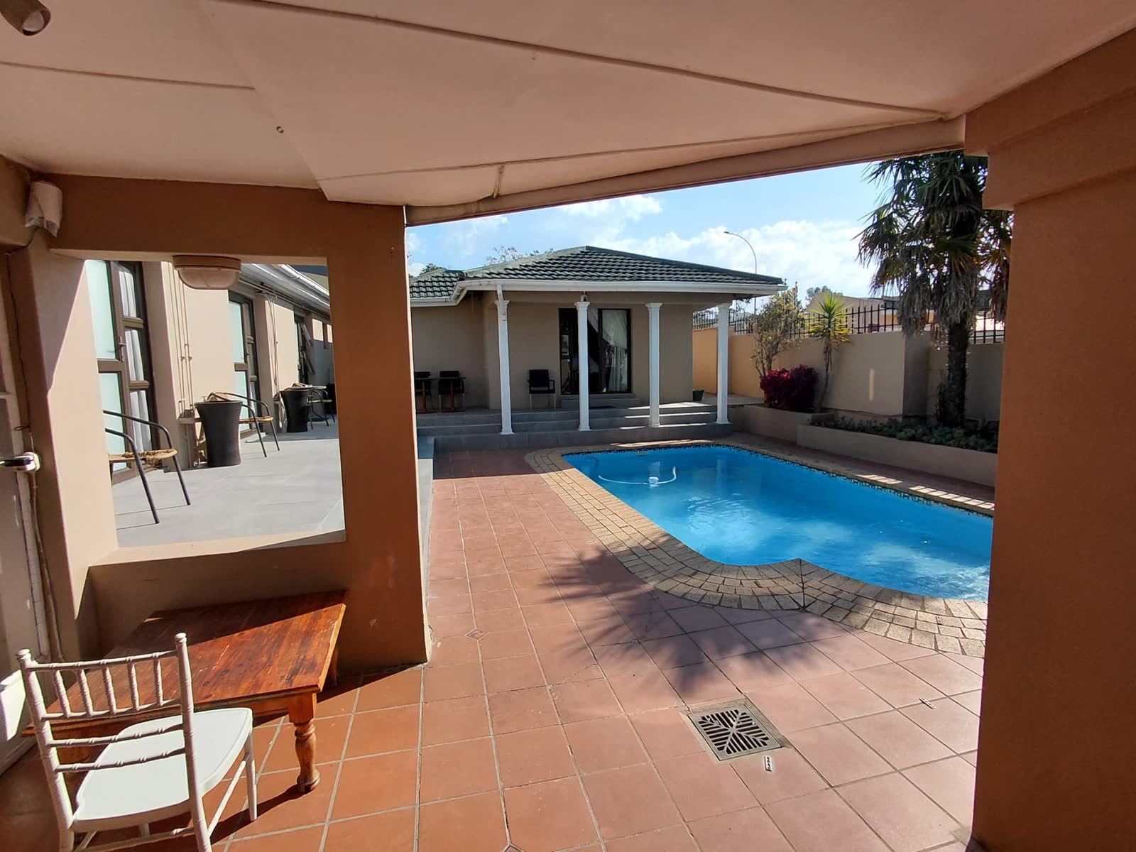 Swimming pool viewed from the shaded guesthouse veranda